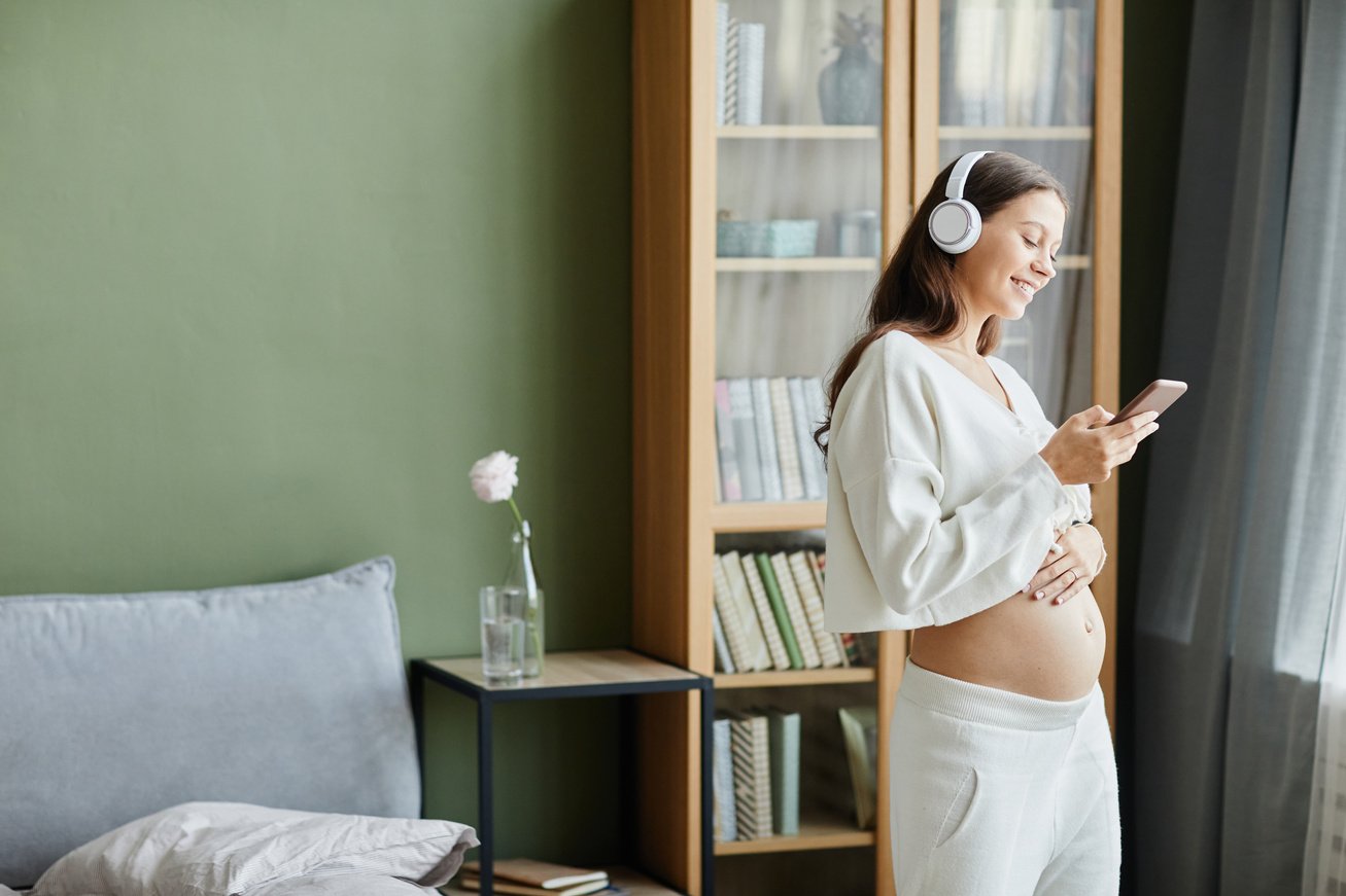 Woman using musical therapy for pregnancy